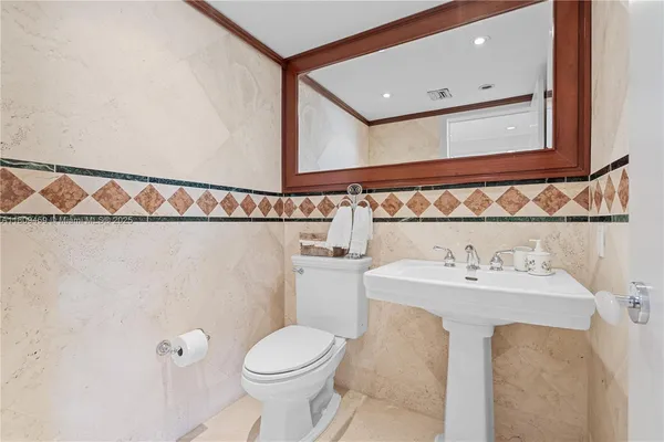 a bathroom with a sink mirror vanity and toilet