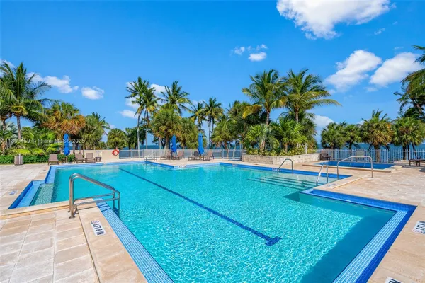a view of a swimming pool with an outdoor space and seating area