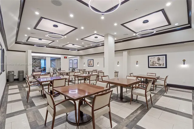 a view of a dining room with furniture and a chandelier