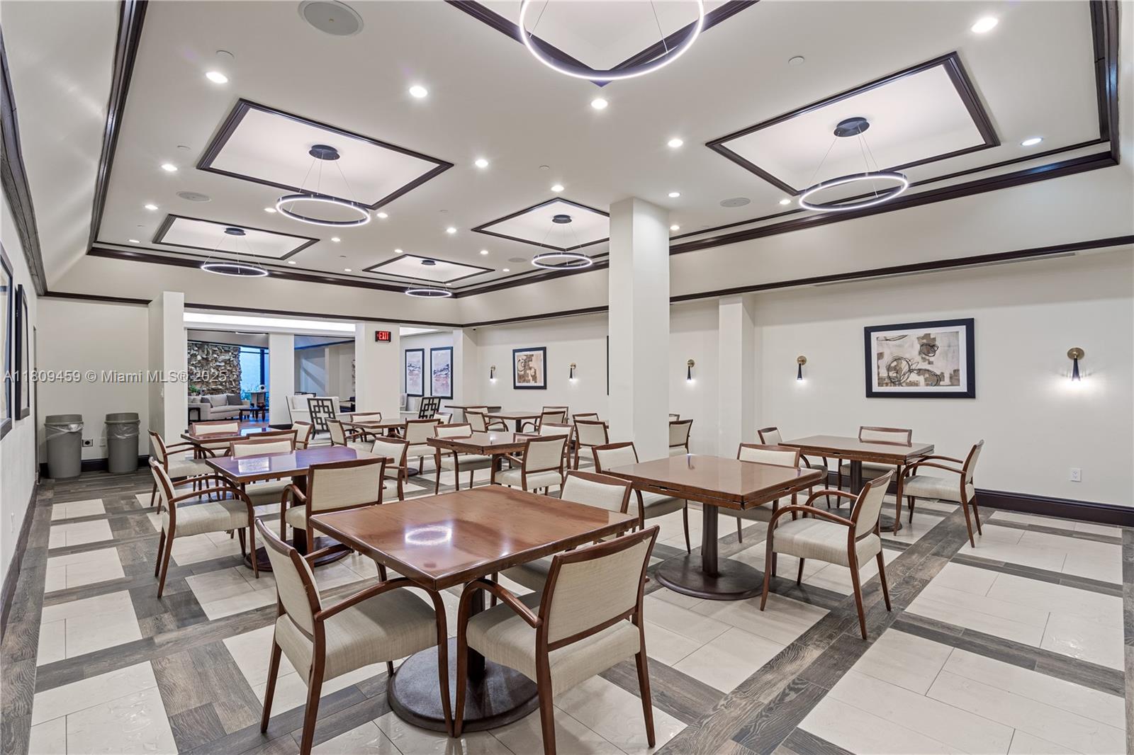 3 Grove Isle Drive, Unit C1610 Miami, FL 33133 - Photo 26 of 33 a view of a dining room with furniture and a chandelier