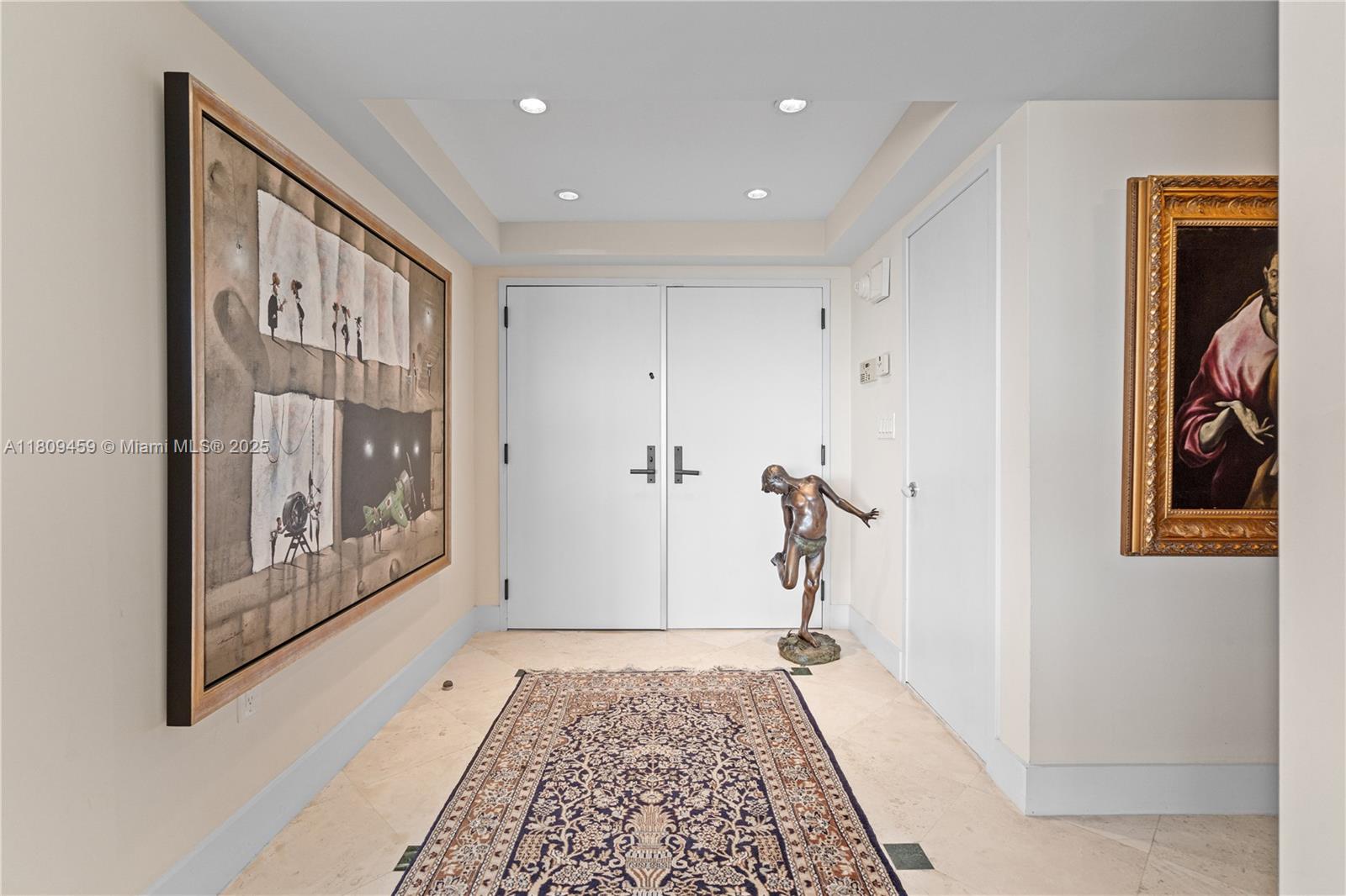 3 Grove Isle Drive, Unit C1610 Miami, FL 33133 - Photo 30 of 33 a view of a hallway with a painting on the wall