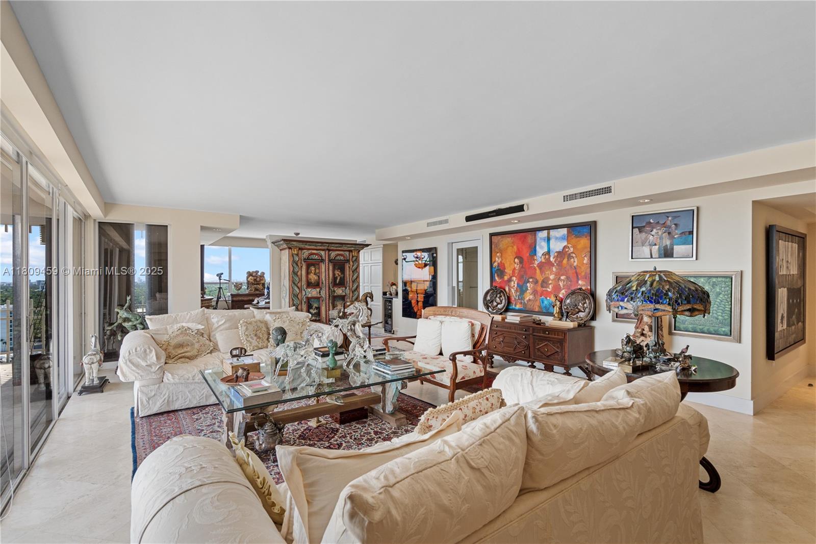 3 Grove Isle Drive, Unit C1610 Miami, FL 33133 - Photo 5 of 33 a living room with furniture and a flat screen tv