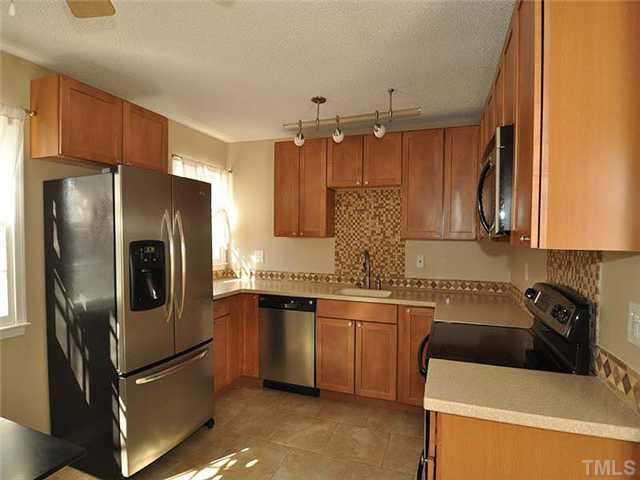 7804 Nugget Lane Raleigh, NC 27615 - Photo 4 of 10 a kitchen with stainless steel appliances a refrigerator sink and microwave