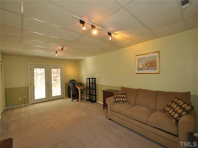 7804 Nugget Lane Raleigh, NC 27615 - Photo 7 of 10 a living room with furniture and a flat screen tv