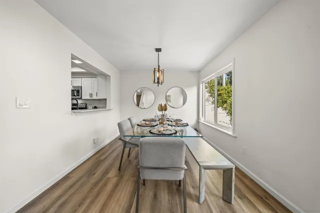 a view of a dining room with furniture window and wooden floor