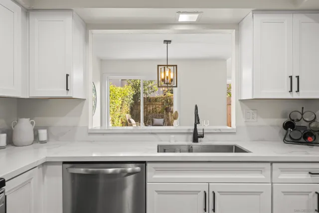 a kitchen with appliances cabinets and a window