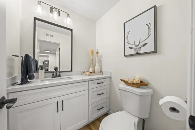 a bathroom with a toilet a sink and mirror