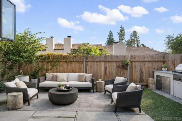 a view of a patio with couches and potted plants