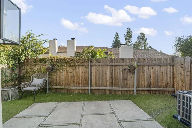 a view of a chair and table in the garden