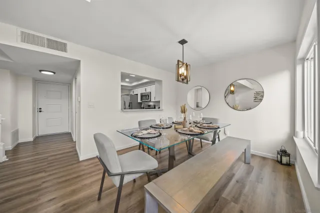 a view of a dining room with furniture and wooden floor