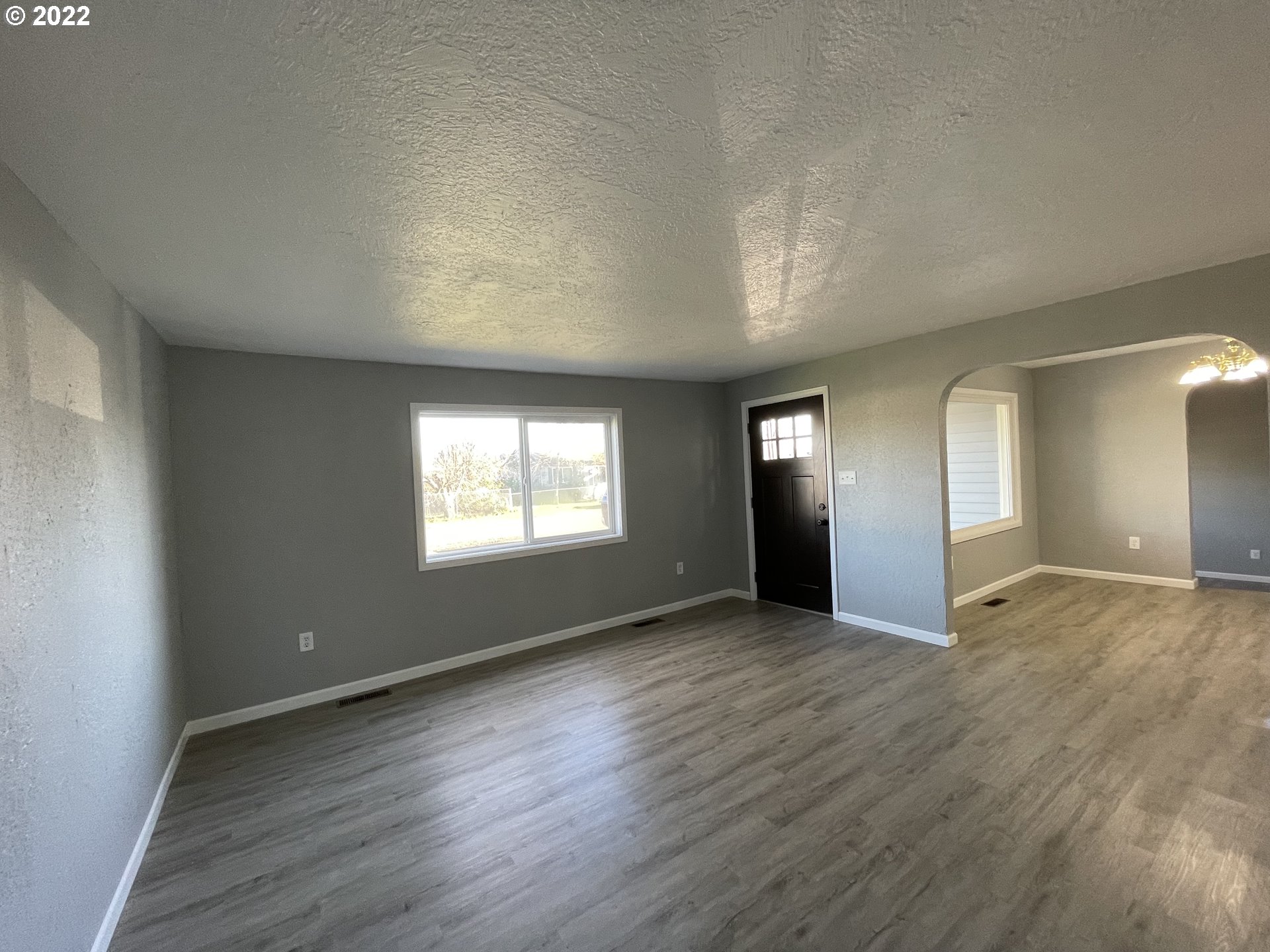 616 32nd Street Springfield, OR 97478 - Photo 16 of 28 an empty room with wooden floor and windows