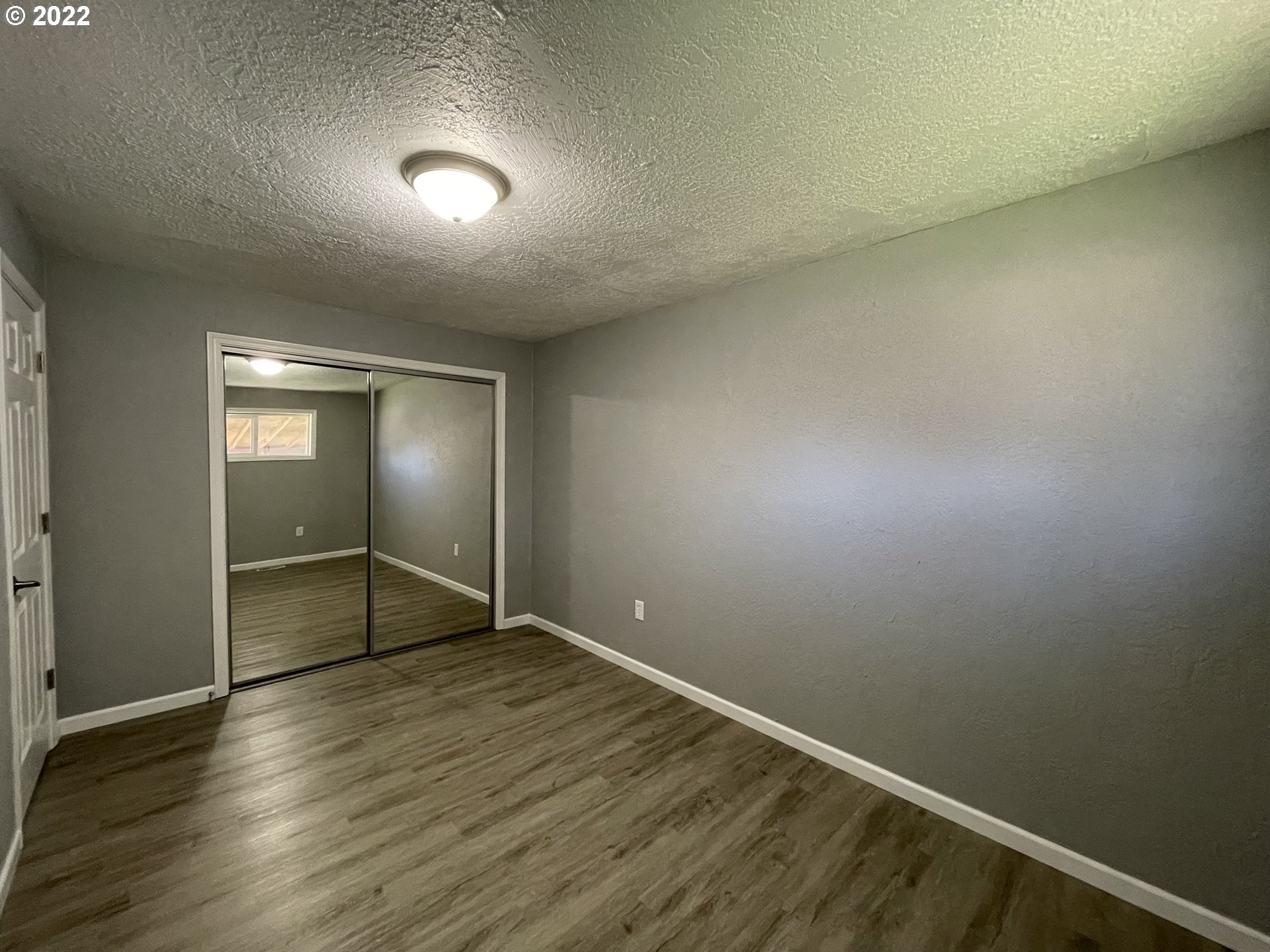 616 32nd Street Springfield, OR 97478 - Photo 17 of 28 an empty room with wooden floor and windows