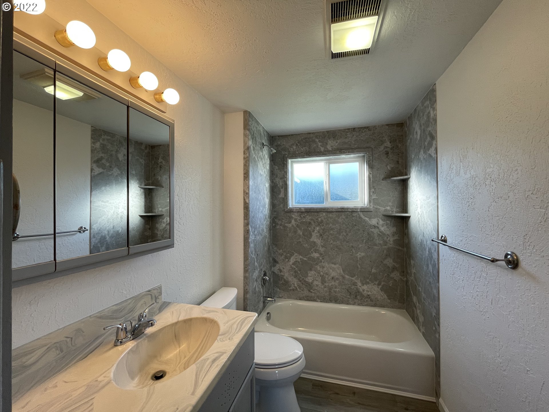 616 32nd Street Springfield, OR 97478 - Photo 19 of 28 a bathroom with a bathtub shower sink mirror and toilet