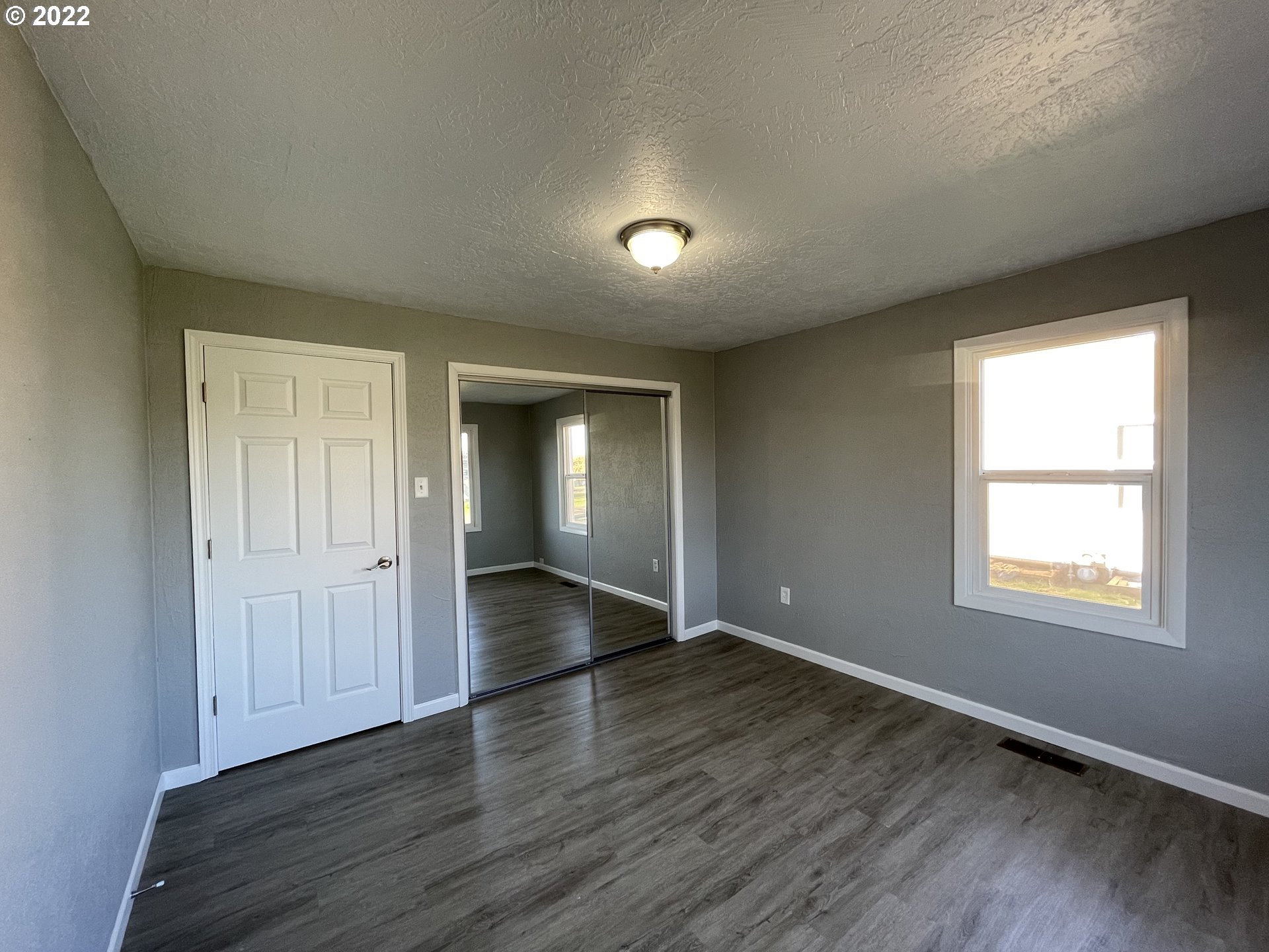 616 32nd Street Springfield, OR 97478 - Photo 25 of 28 an empty room with wooden floor and windows