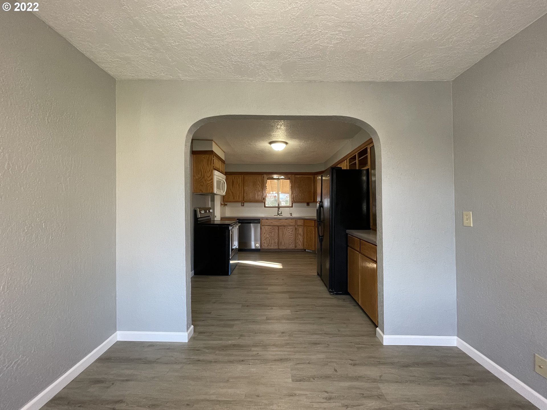 616 32nd Street Springfield, OR 97478 - Photo 5 of 28 a view of a big room with wooden floor and a kitchen
