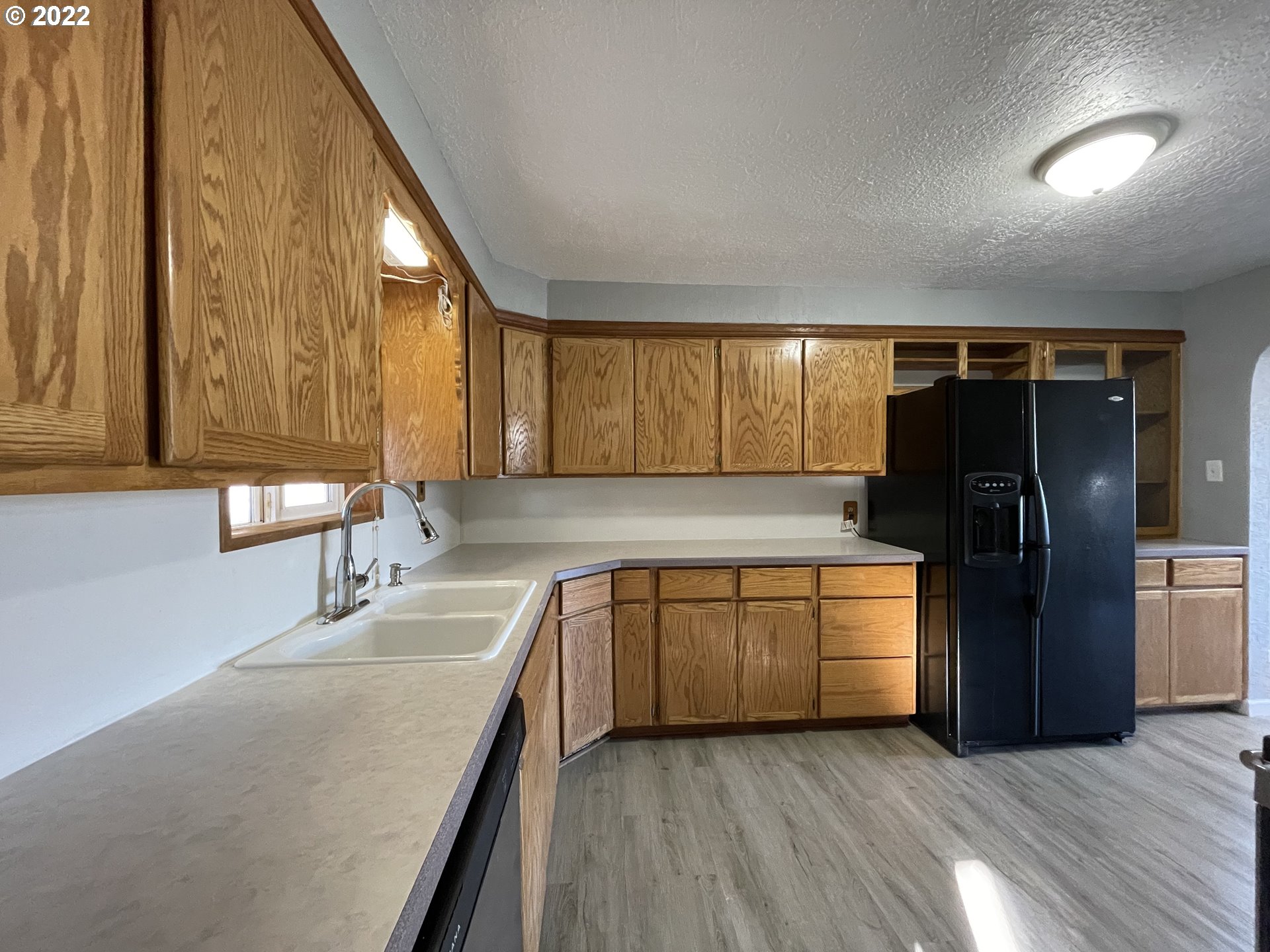 616 32nd Street Springfield, OR 97478 - Photo 6 of 28 a kitchen with stainless steel appliances granite countertop a refrigerator and a sink