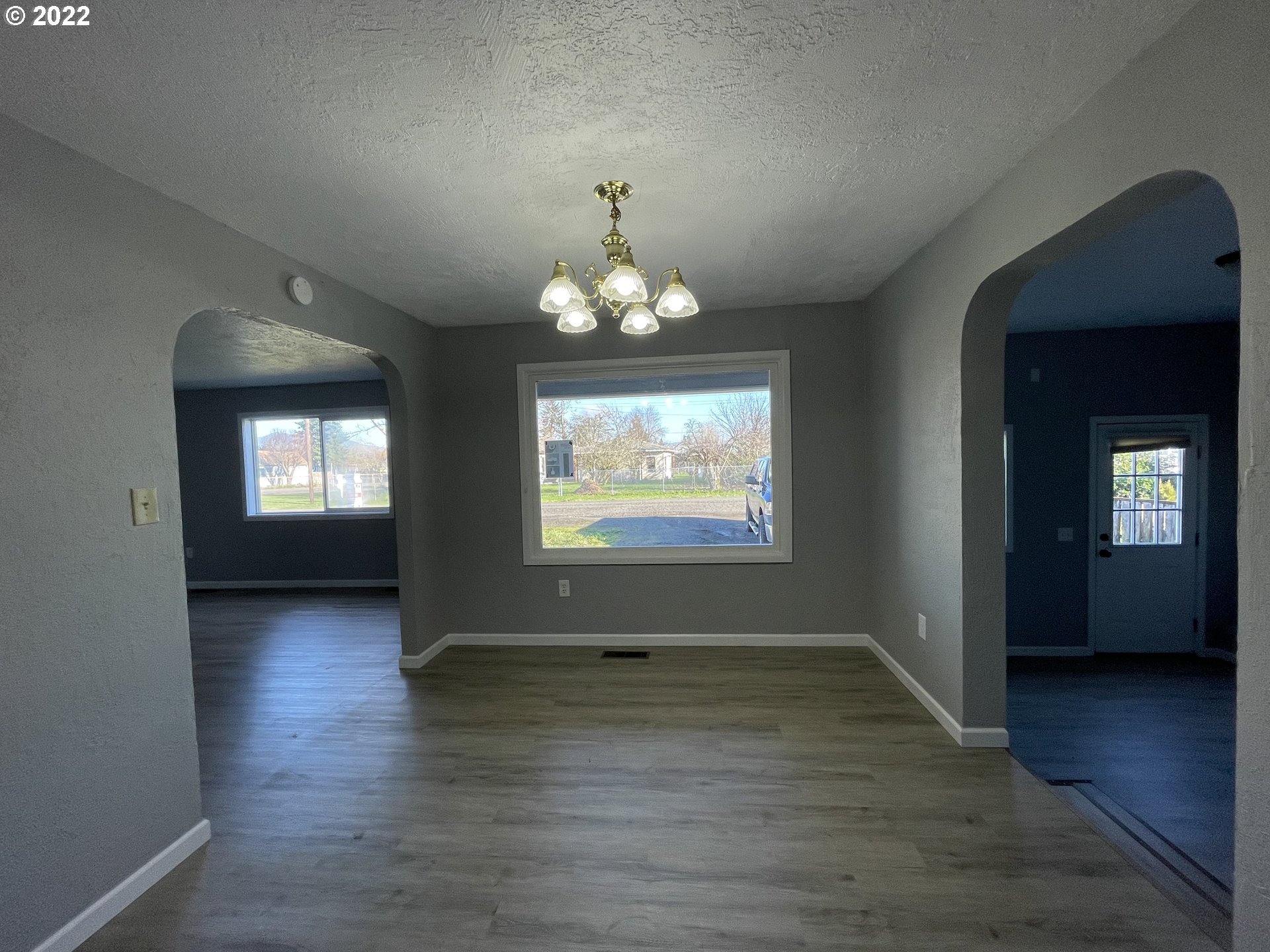 616 32nd Street Springfield, OR 97478 - Photo 9 of 28 an empty room with wooden floor and windows
