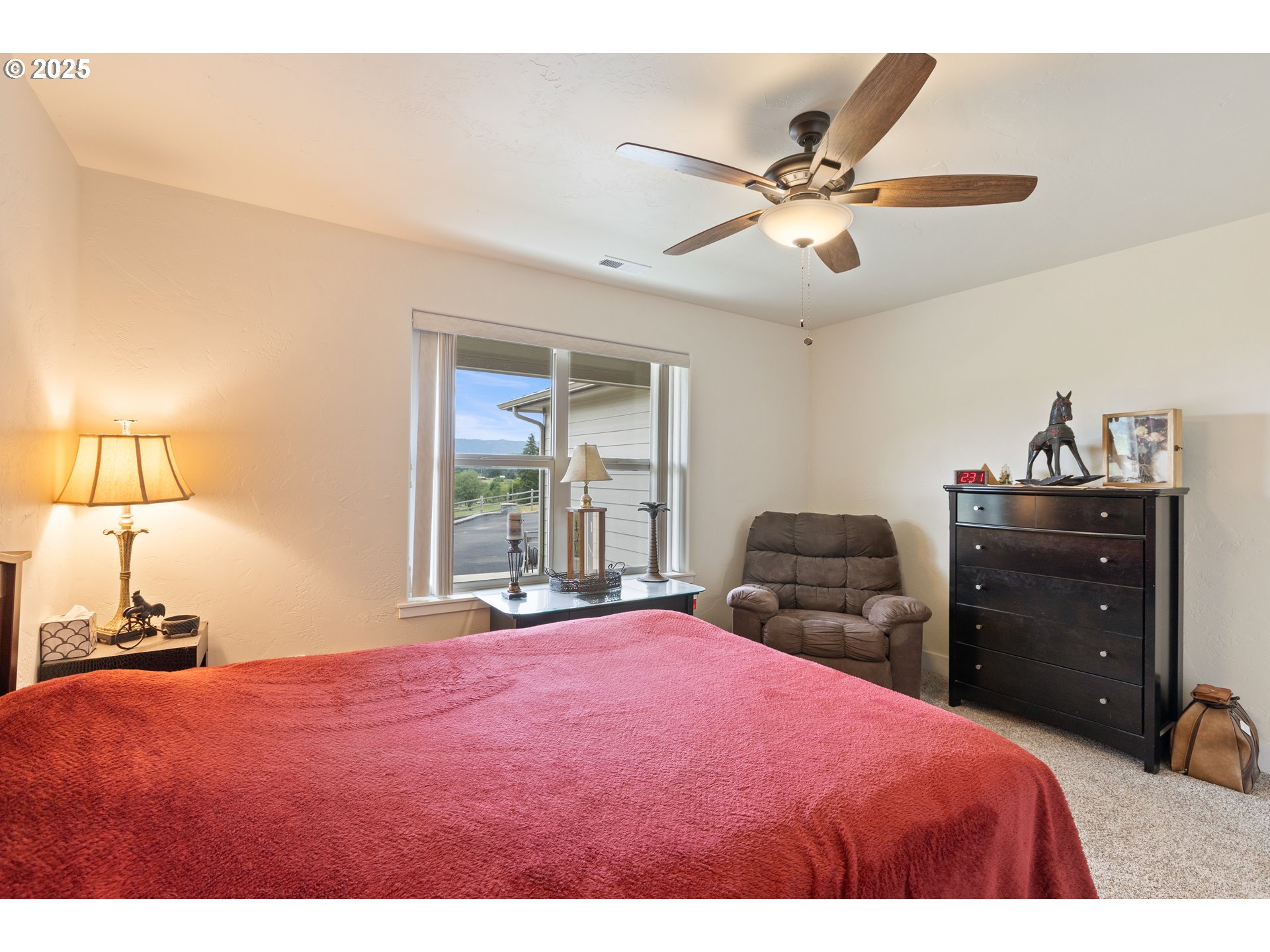 910 Swallow Avenue Sutherlin, OR 97479 - Photo 26 of 44 a bedroom with a bed and a chandelier