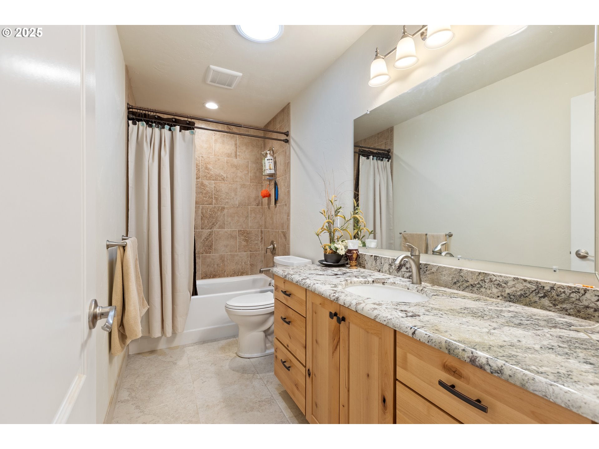 910 Swallow Avenue Sutherlin, OR 97479 - Photo 28 of 44 a bathroom with a granite countertop sink a toilet a mirror and shower