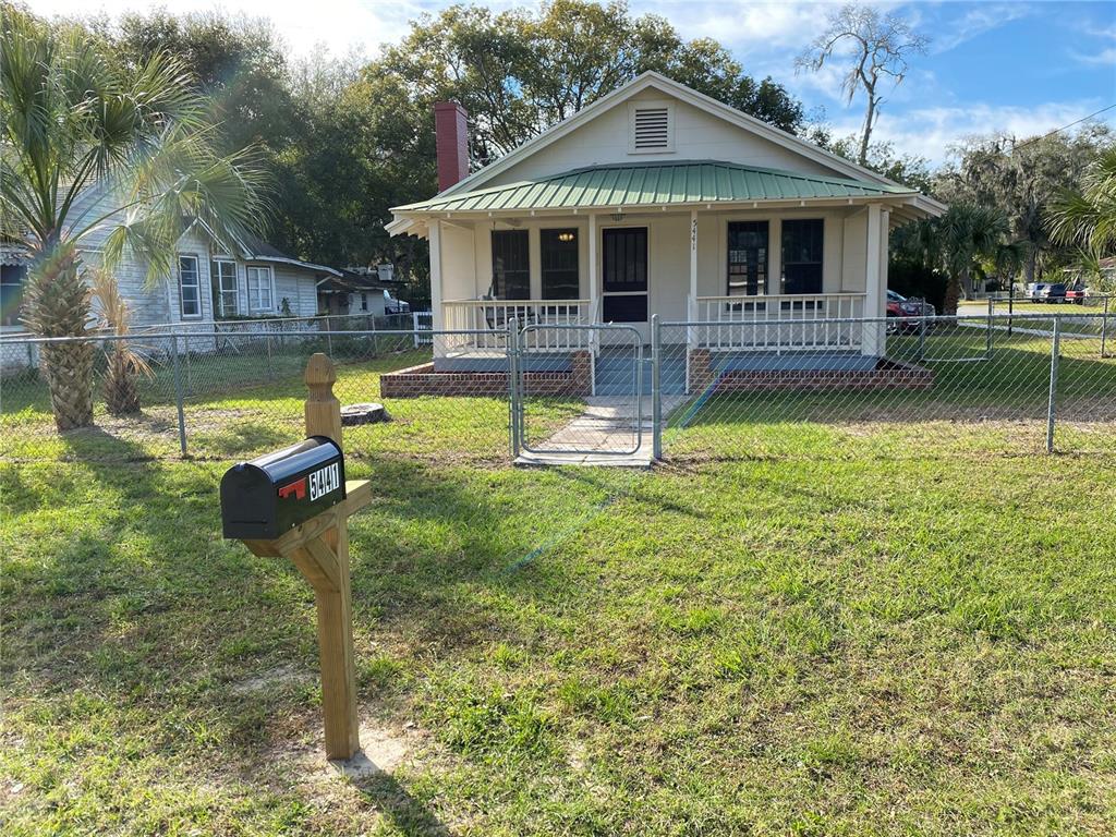 a front view of a house with a yard table and chairs