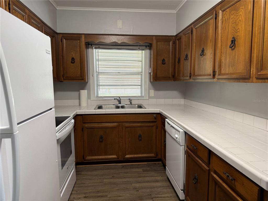 5441 18th Street Zephyrhills, FL 33542 - Photo 12 of 50 a kitchen with stainless steel appliances granite countertop a sink and a refrigerator