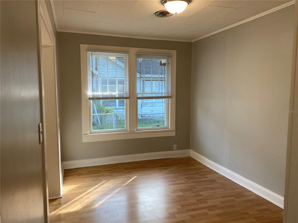 5441 18th Street Zephyrhills, FL 33542 - Photo 17 of 50 a view of an empty room with a window and wooden floor