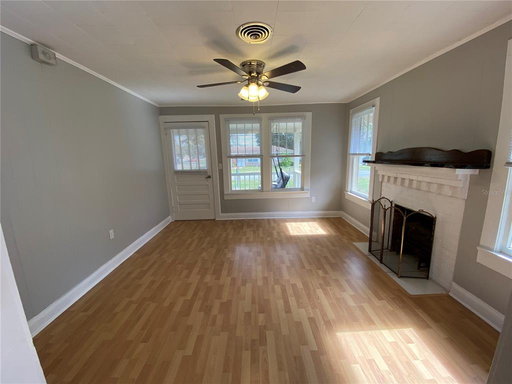 5441 18th Street Zephyrhills, FL 33542 - Photo 18 of 50 a view of empty room with wooden floor and fan