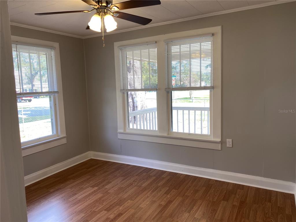5441 18th Street Zephyrhills, FL 33542 - Photo 22 of 50 a view of an empty room with wooden floor and a window