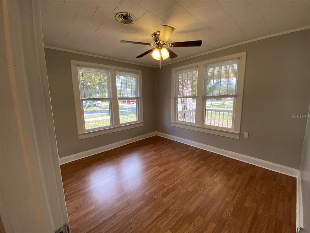 5441 18th Street Zephyrhills, FL 33542 - Photo 23 of 50 a view of an empty room with wooden floor and a window