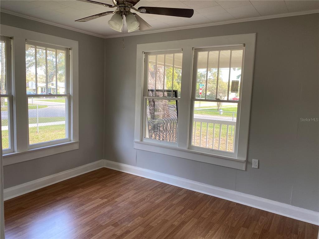 5441 18th Street Zephyrhills, FL 33542 - Photo 24 of 50 a view of an empty room with wooden floor and a window