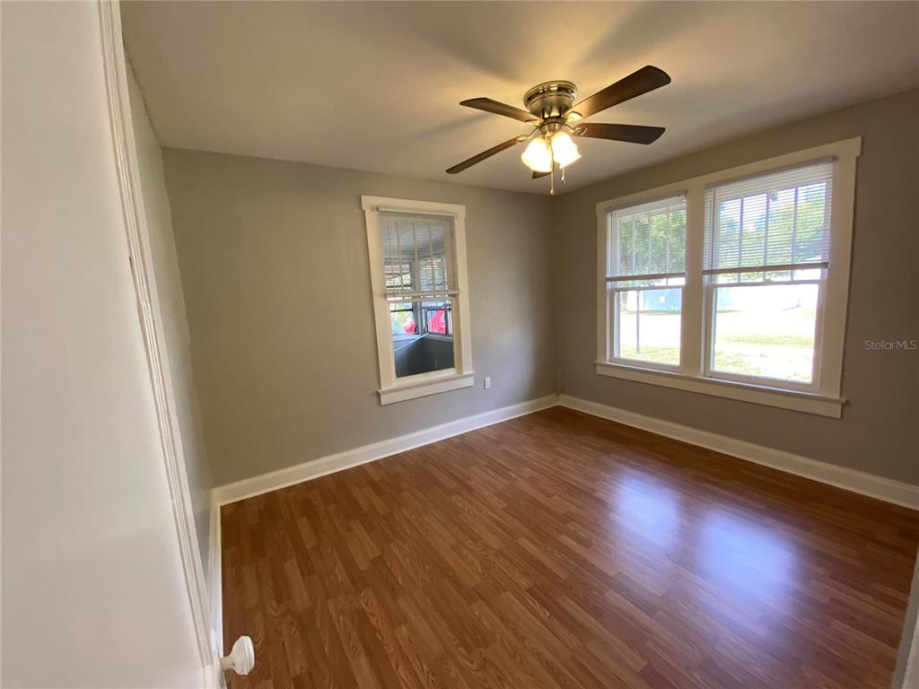 5441 18th Street Zephyrhills, FL 33542 - Photo 31 of 50 a view of an empty room with wooden floor and a window