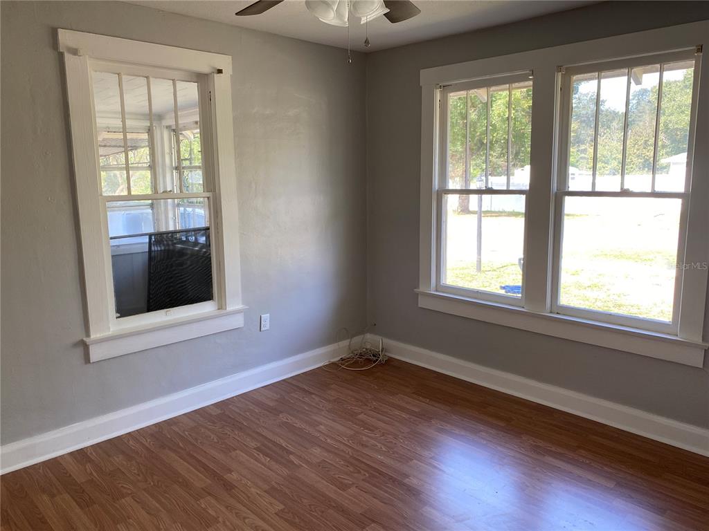 5441 18th Street Zephyrhills, FL 33542 - Photo 32 of 50 a view of an empty room with wooden floor and a window