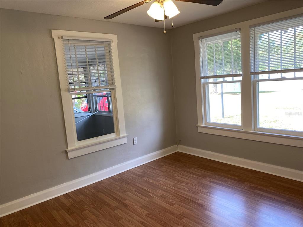 5441 18th Street Zephyrhills, FL 33542 - Photo 33 of 50 a view of an empty room with wooden floor and a window