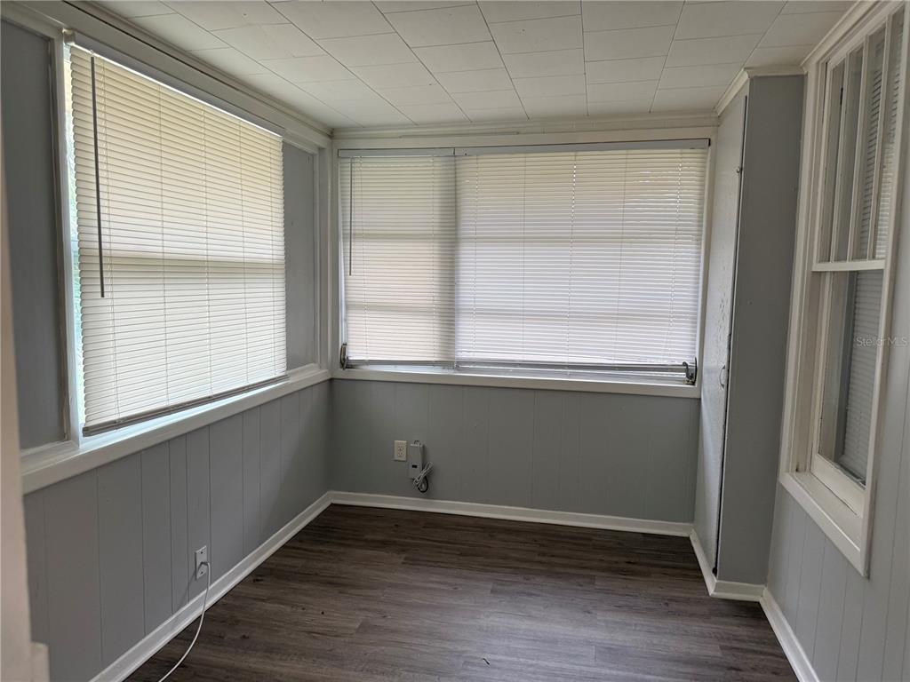 5441 18th Street Zephyrhills, FL 33542 - Photo 35 of 50 a view of an empty room with wooden floor and a window