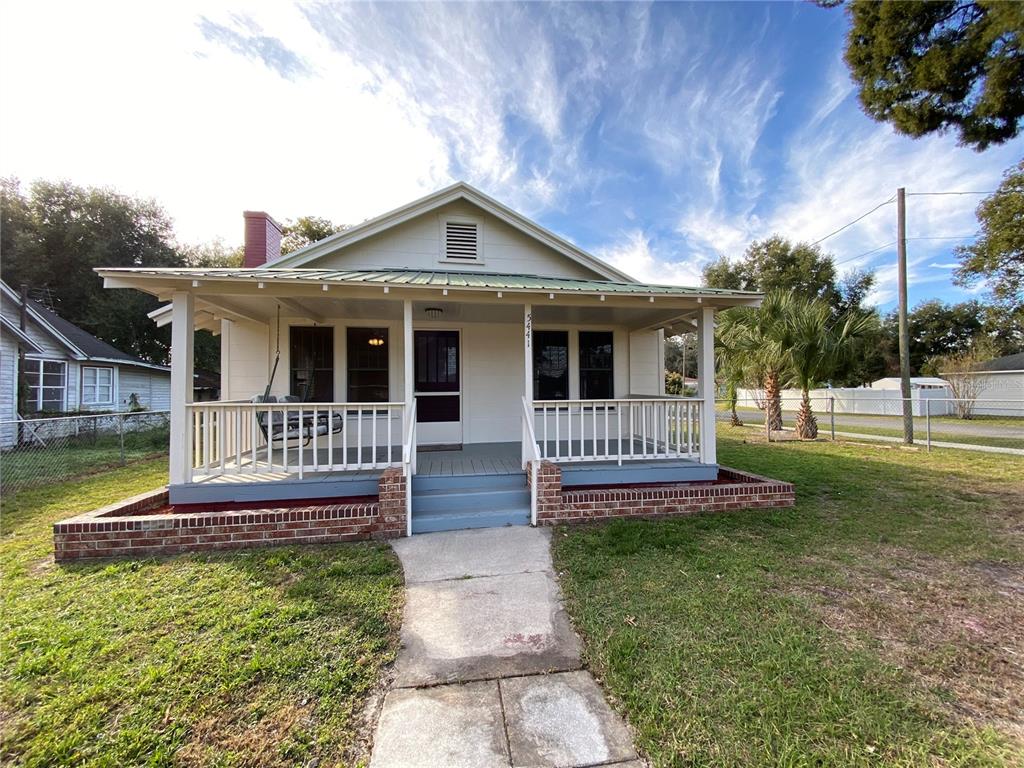 5441 18th Street Zephyrhills, FL 33542 - Photo 7 of 50 a front view of a house with a yard table and chairs