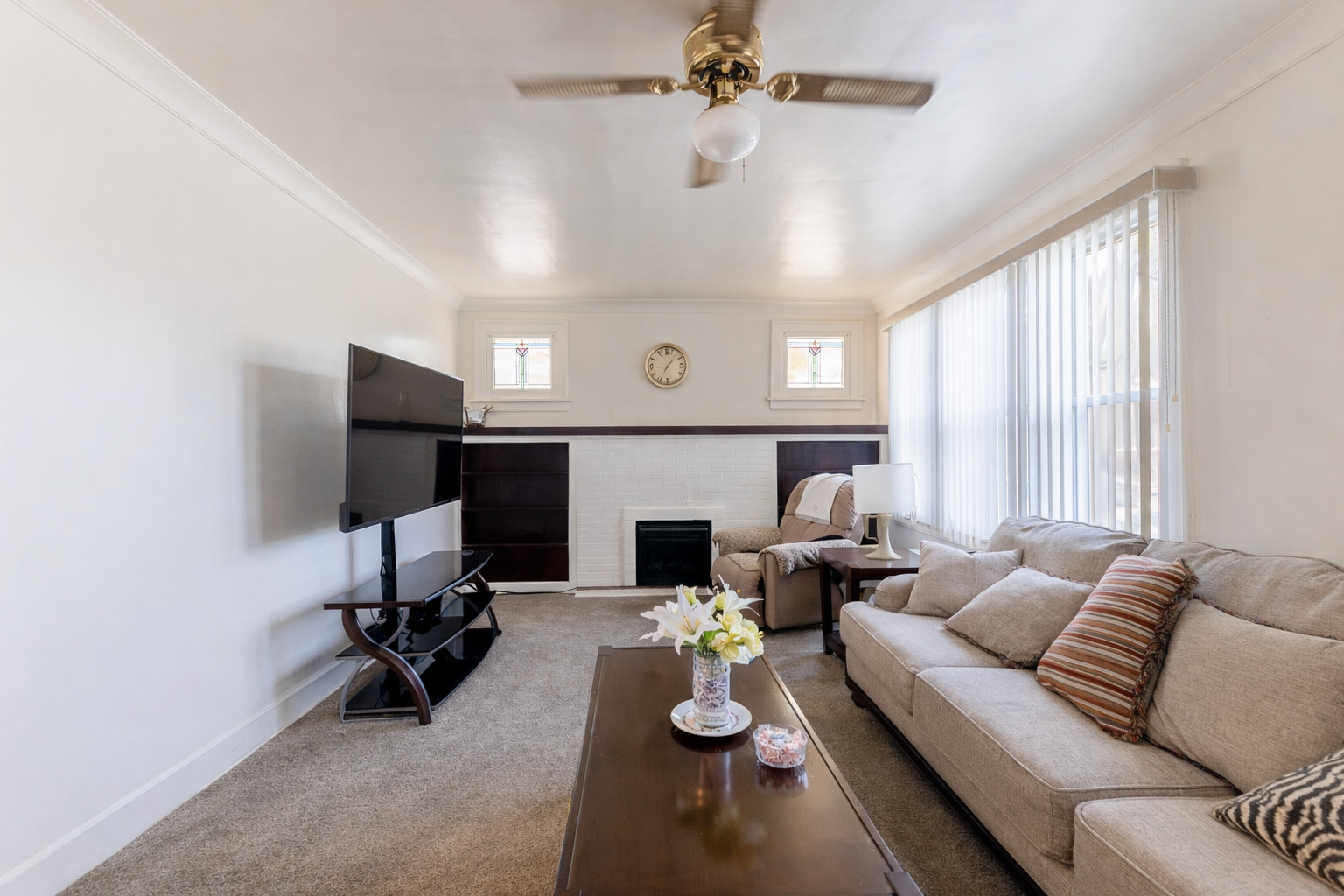 8129 South Cornell Avenue Chicago, IL 60617 - Photo 4 of 18 a living room with furniture and a fireplace