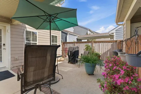 a patio with a patio table and chairs under an umbrella