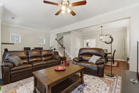 a living room with furniture and wooden floor