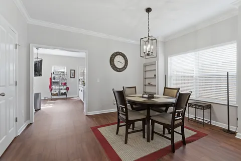 a view of a dining room with furniture wooden floor and a chandelier