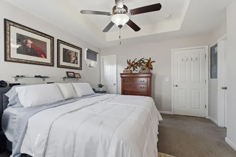 a bedroom with a bed and a chandelier