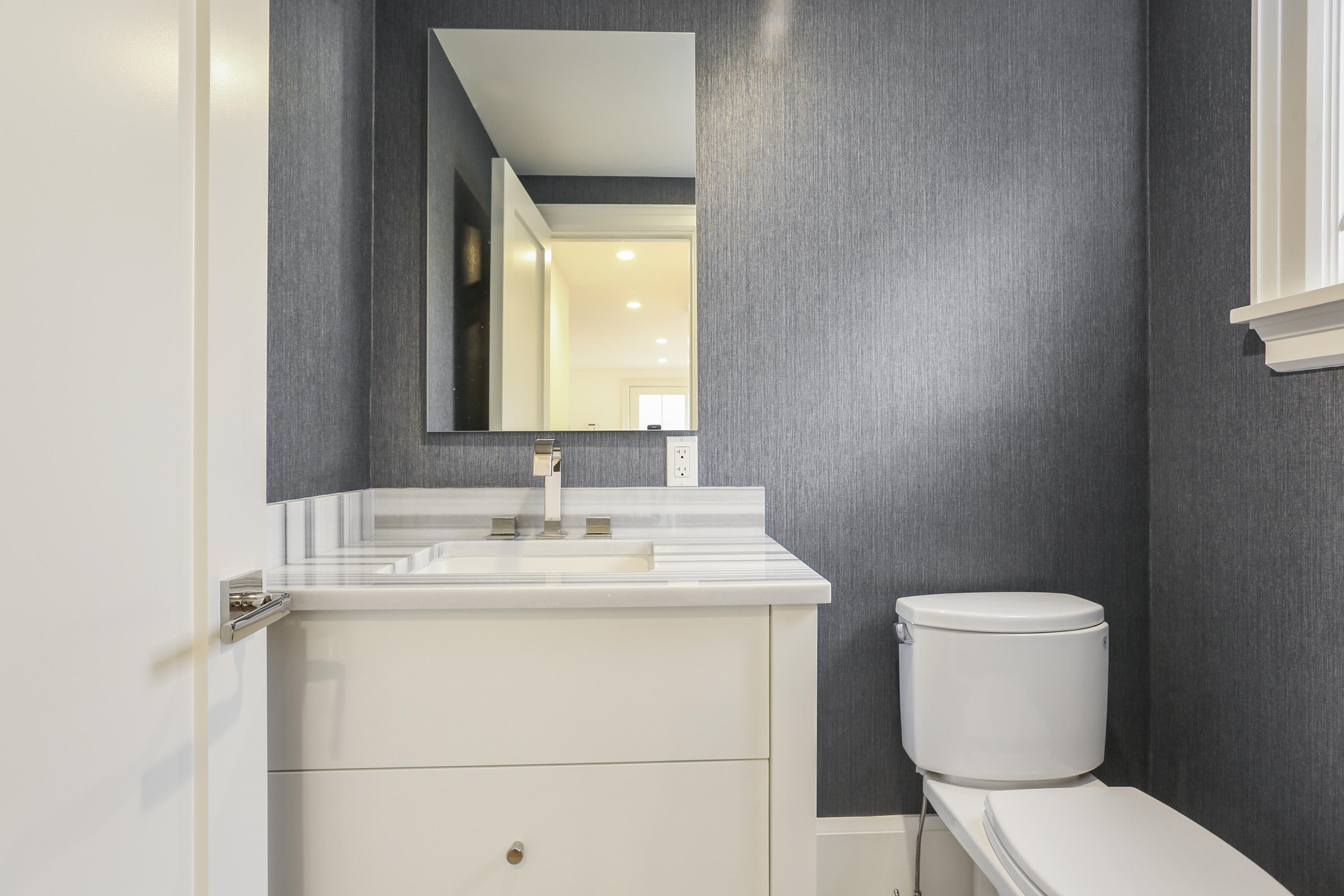 693 Post Road Darien, CT 06820 - Photo 12 of 41 a bathroom with a toilet sink and mirror
