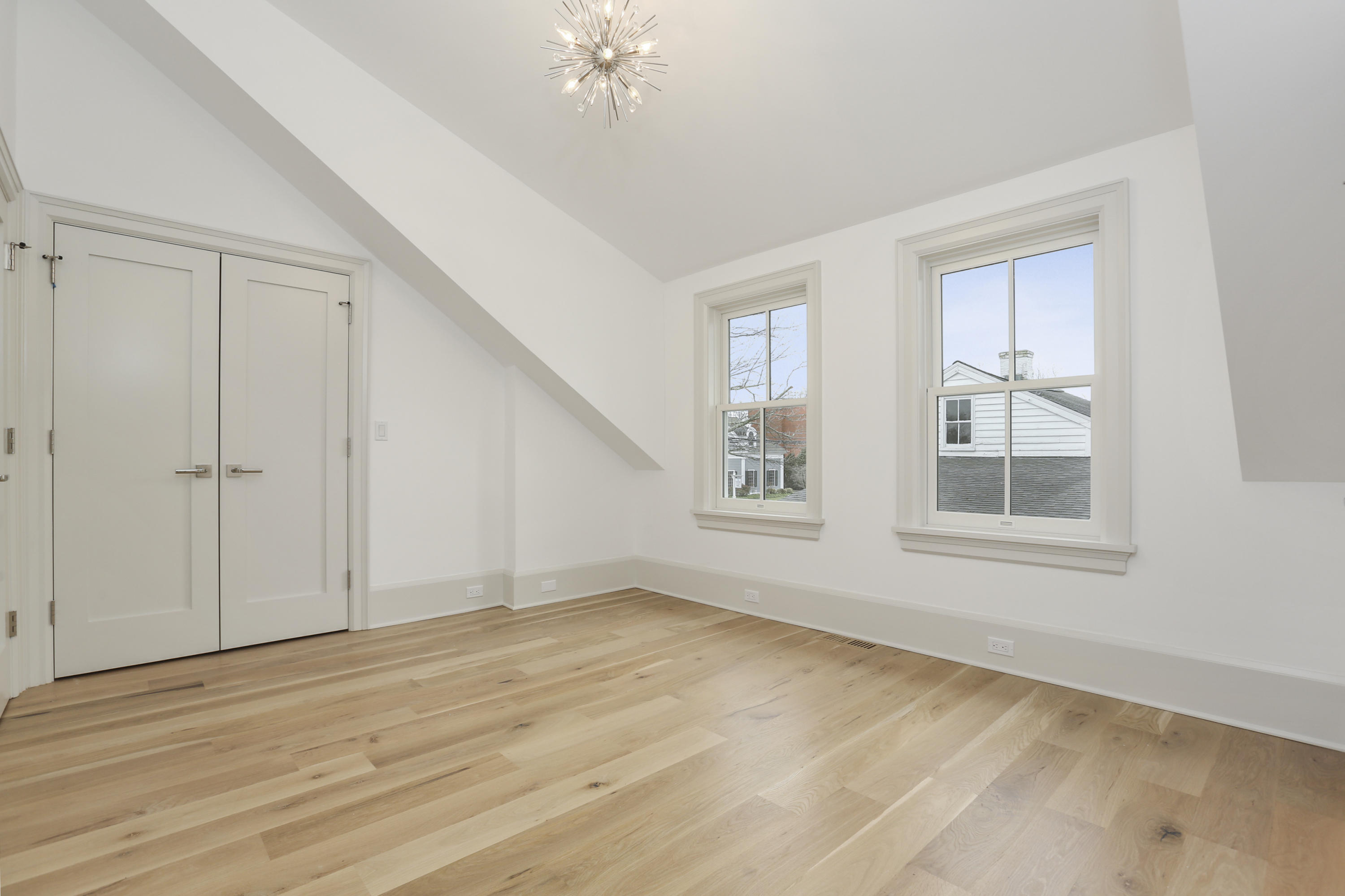 693 Post Road Darien, CT 06820 - Photo 19 of 41 a view of an empty room with wooden floor and a window
