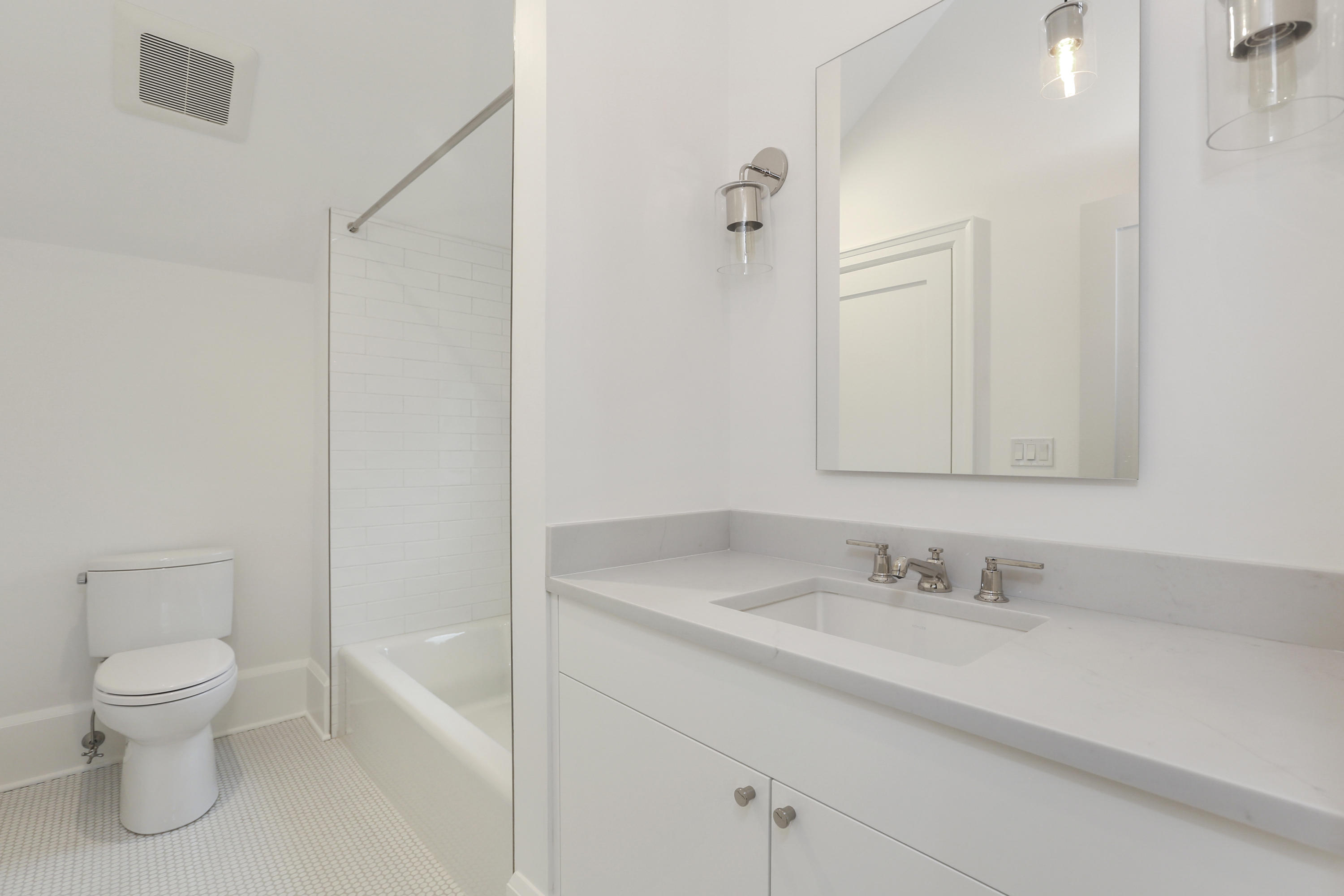 693 Post Road Darien, CT 06820 - Photo 20 of 41 a bathroom with a granite countertop sink a toilet and a mirror