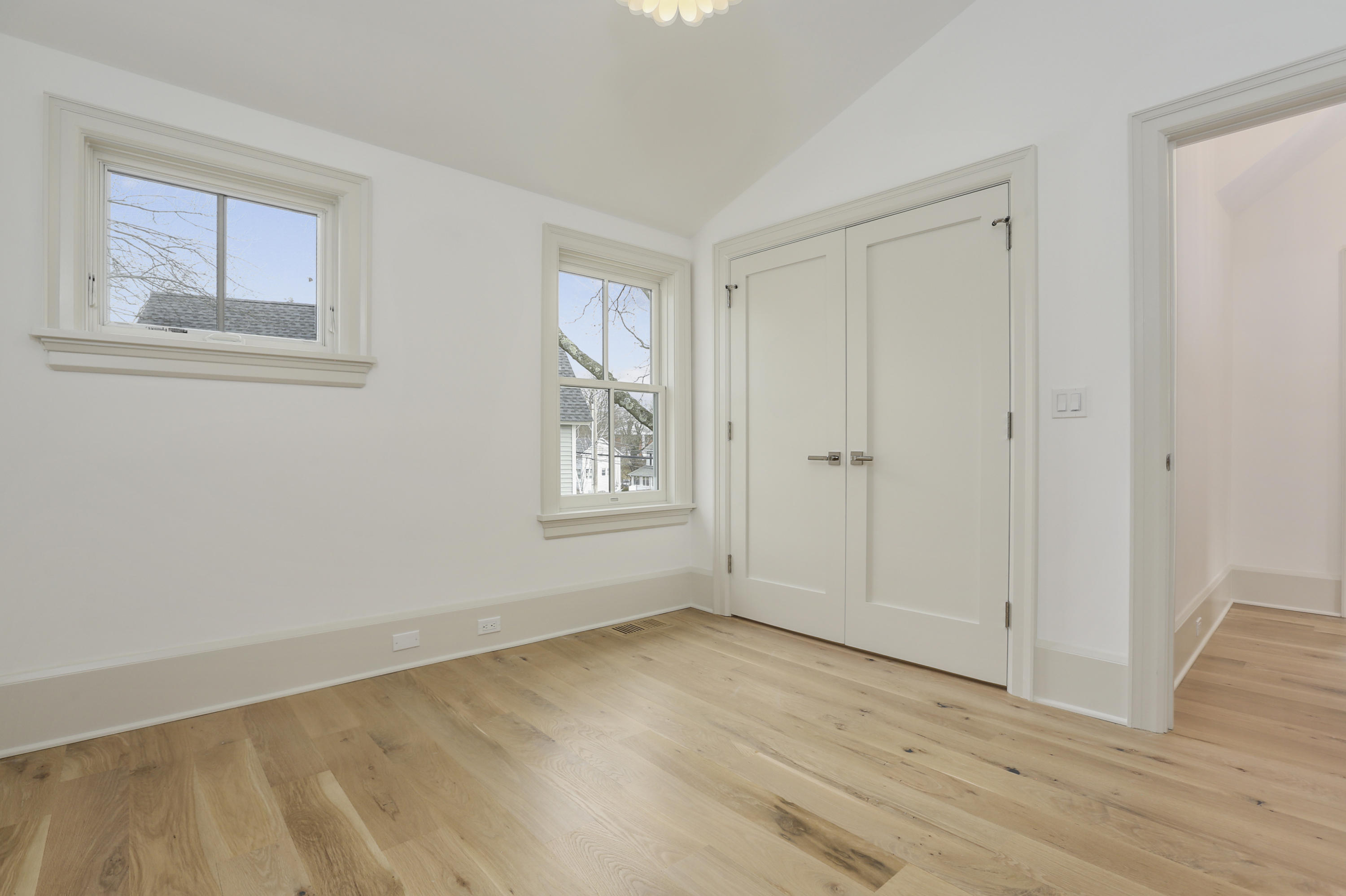 693 Post Road Darien, CT 06820 - Photo 22 of 41 a view of an empty room with wooden floor and a window