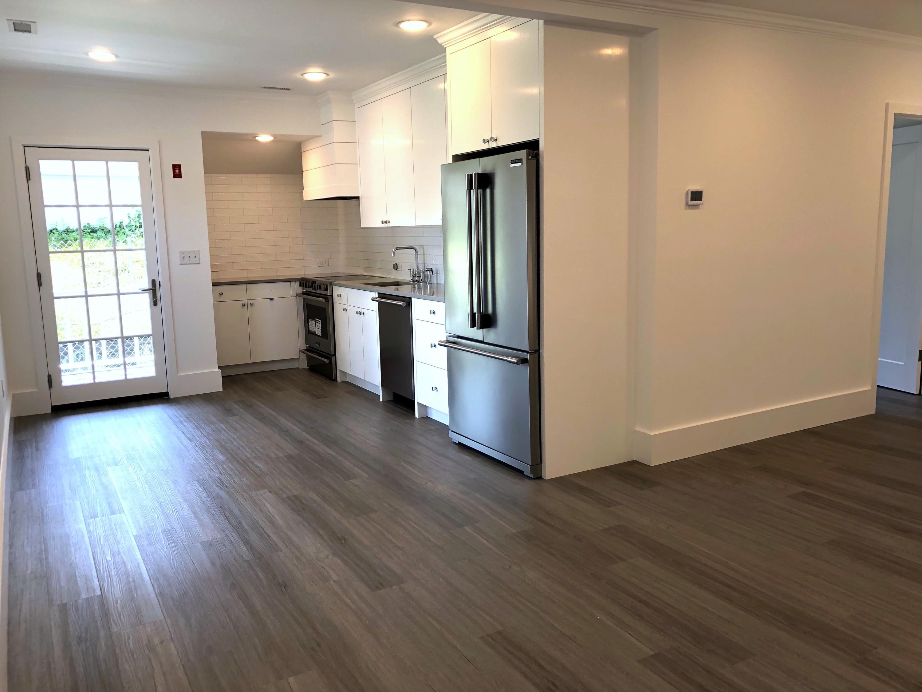 693 Post Road Darien, CT 06820 - Photo 29 of 41 a kitchen with stainless steel appliances granite countertop a refrigerator a sink dishwasher a stove and white countertops with wooden floor