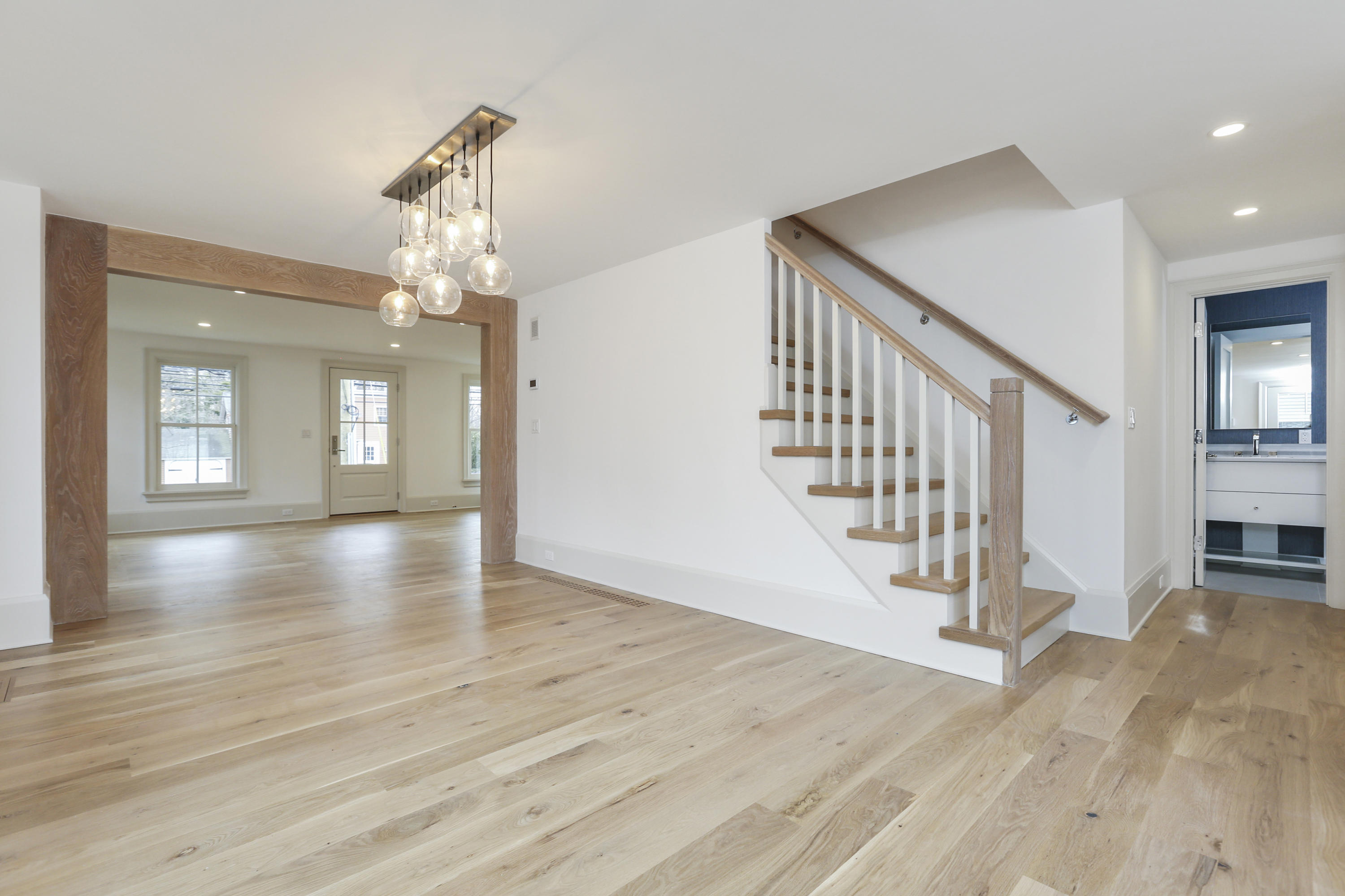 693 Post Road Darien, CT 06820 - Photo 7 of 41 a view of a hallway with wooden floor and staircase