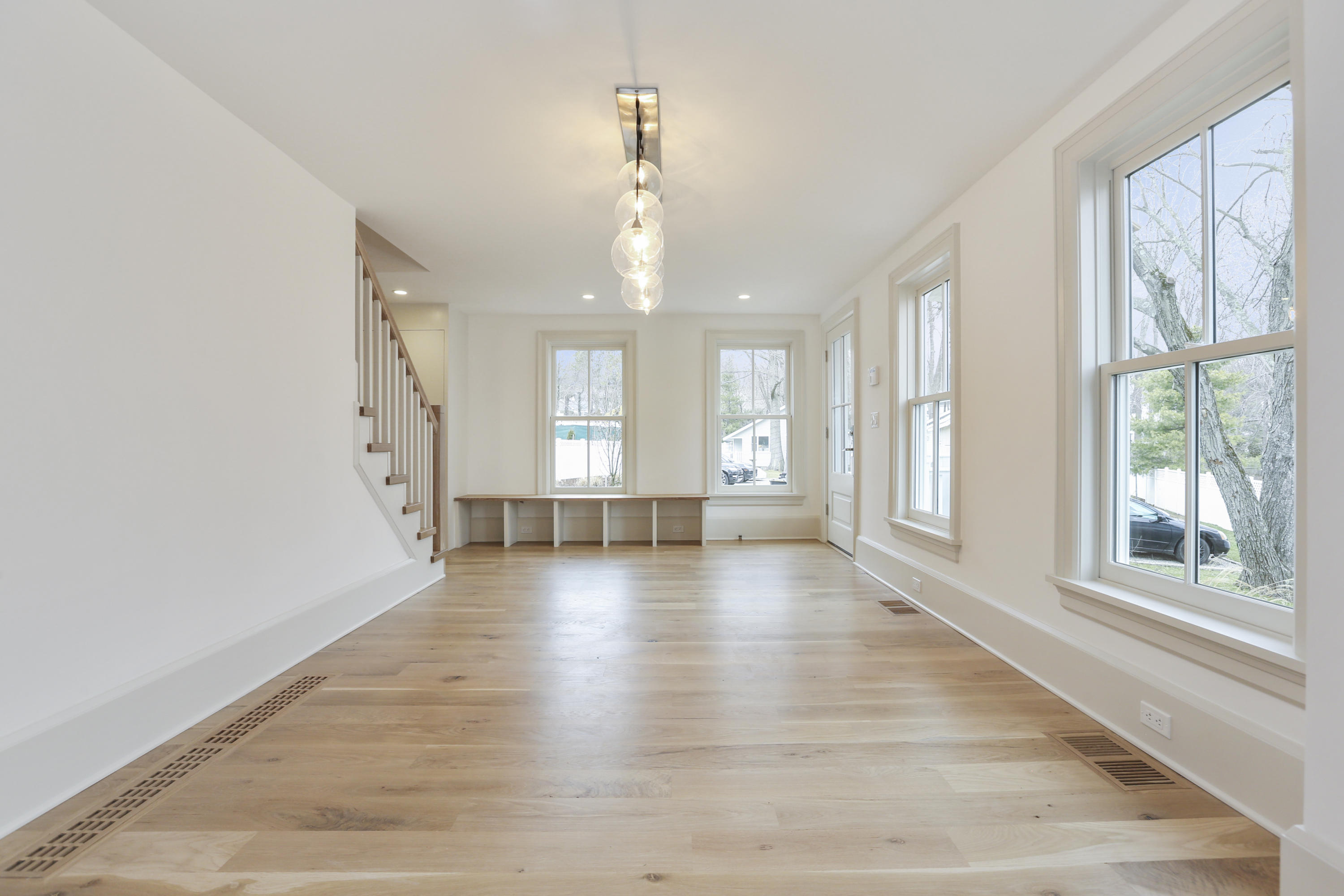 693 Post Road Darien, CT 06820 - Photo 8 of 41 an empty room with wooden floor and windows