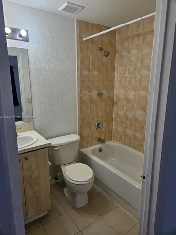 a white toilet sitting next to a bath tub