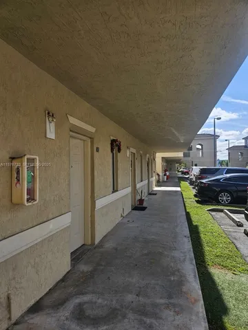 a view of a house with backyard and porch