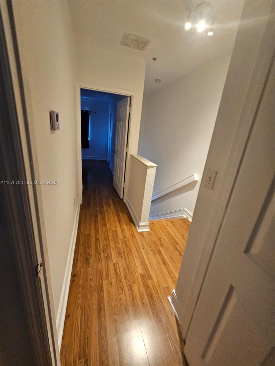 7995 Northwest 8th Street, Unit 103 Miami, FL 33126 - Photo 9 of 17 a view of wooden floor in a room